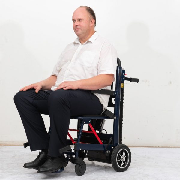 A Person Sitting on EZYSTAIRS Automatic And Safe Stair Climber Chair A Person Sitting on EZYSTAIRS Automatic And Safe Stair Climber Chair